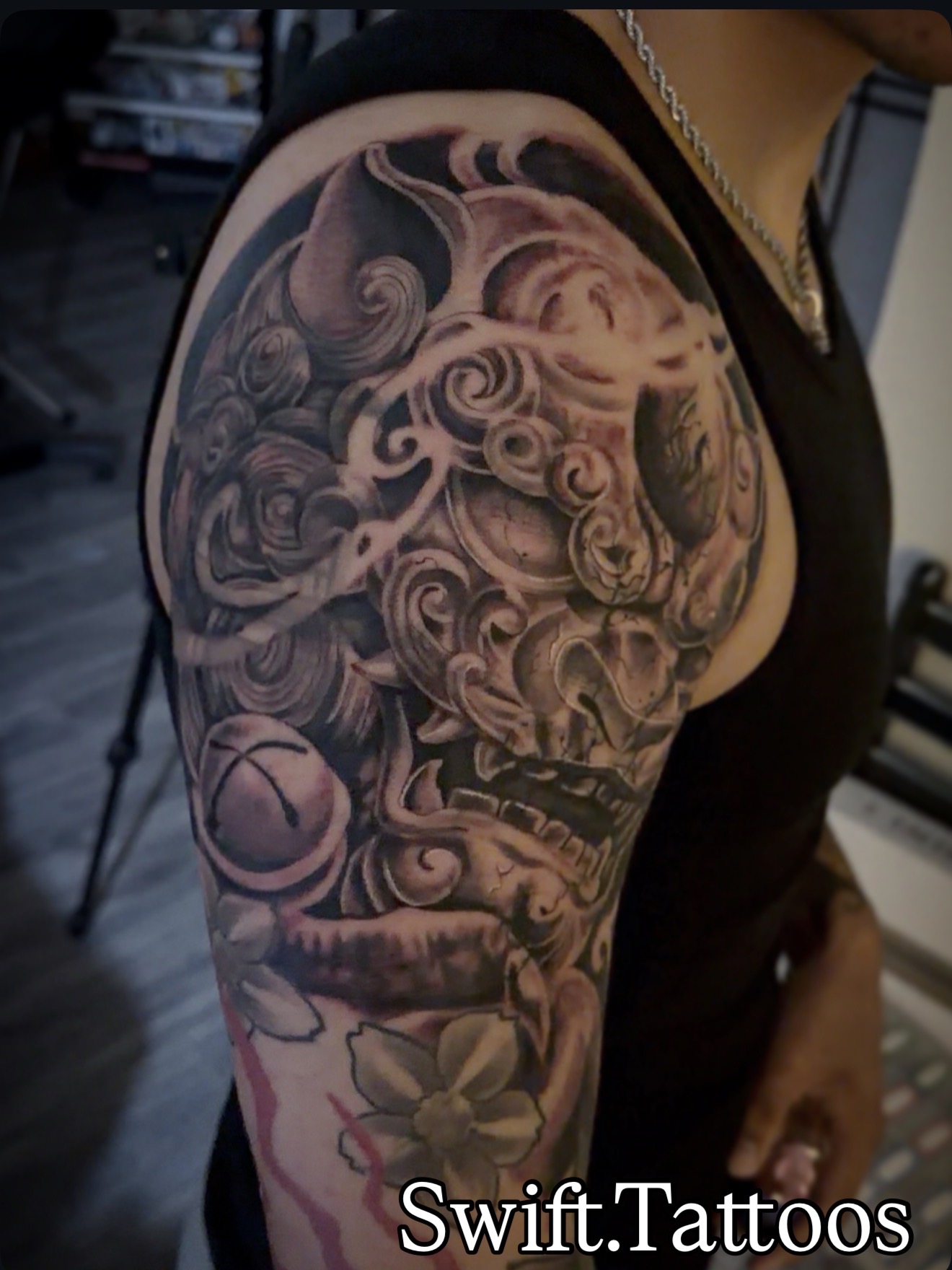 Large black and grey mask tattoo by Swift