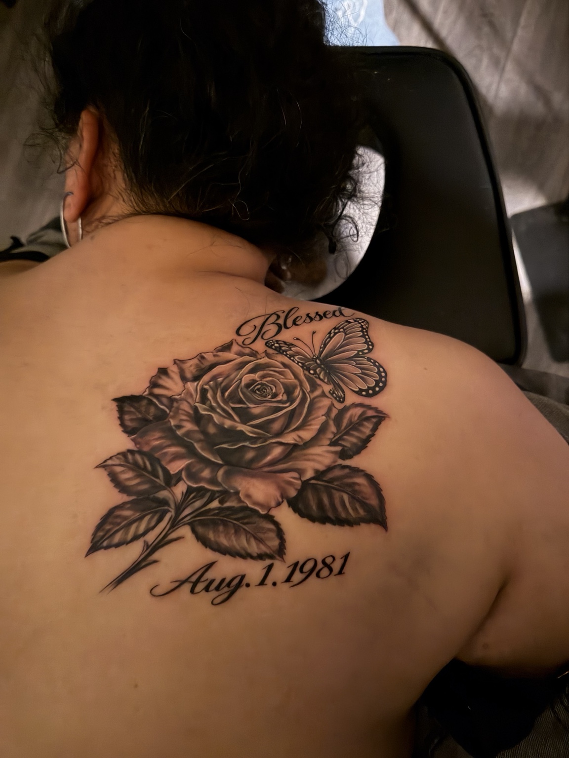 Black and grey rose and butterfly back tattoo by Swift